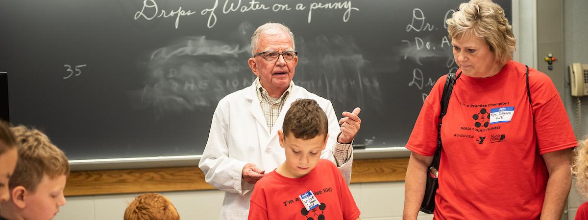 Photo of Professor Friedel working with students.
