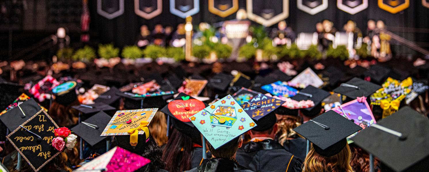 Crowd shot of decorated caps during the 2022 commencement.