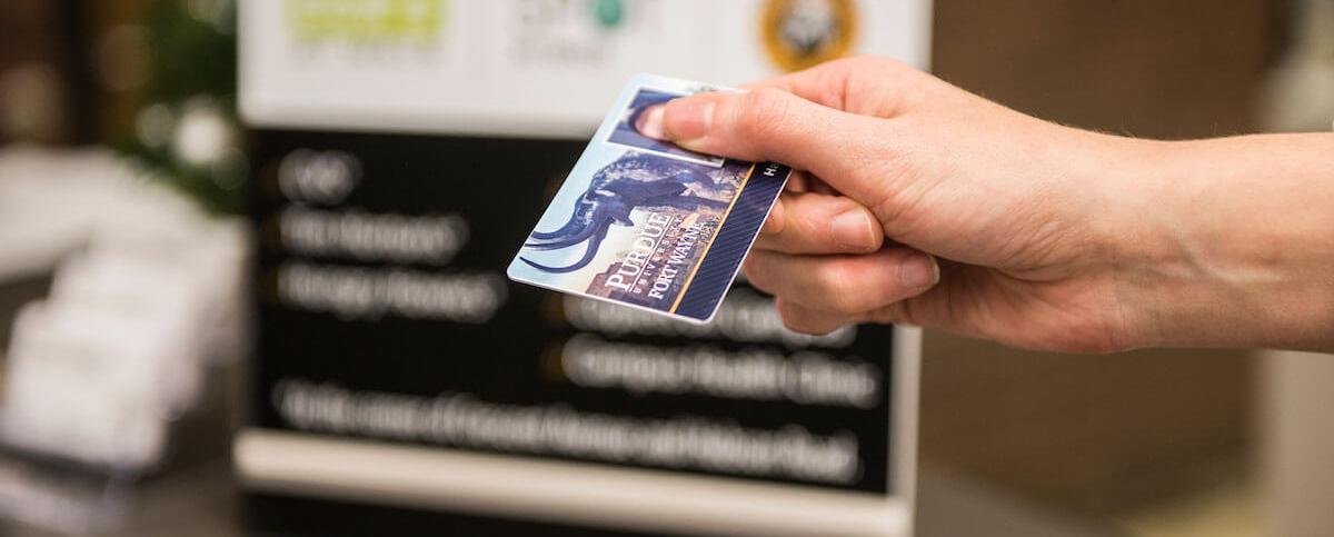 A student is using their Mastodon ID card to make a purchase