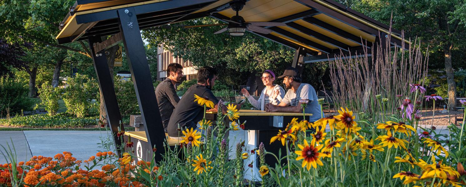 Students sitting in the solar hut