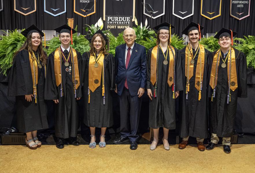 Group of 2025 Chapman Scholar graduates with Mr. Howard Chapman