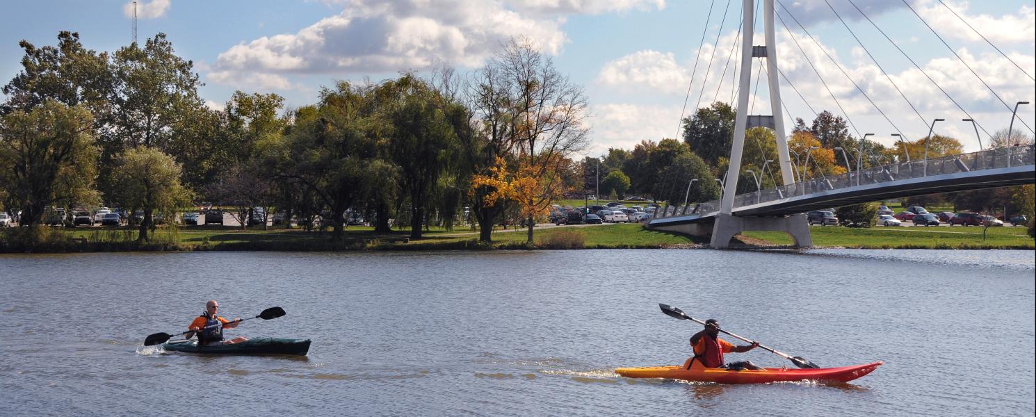 Kayaks on the St. Joseph River with the Ron Venderly Family Pedestrian bridge in the background.