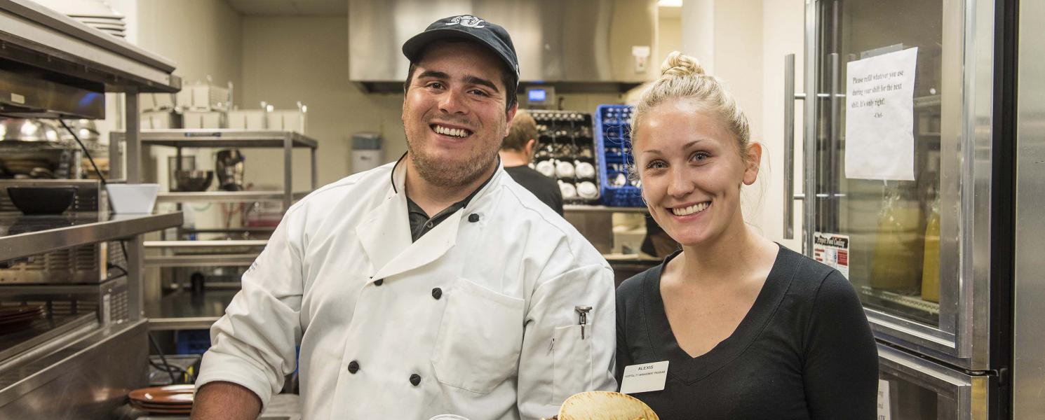 Hospitality and Tourism Management students working in the hotel restaurant lab setting.