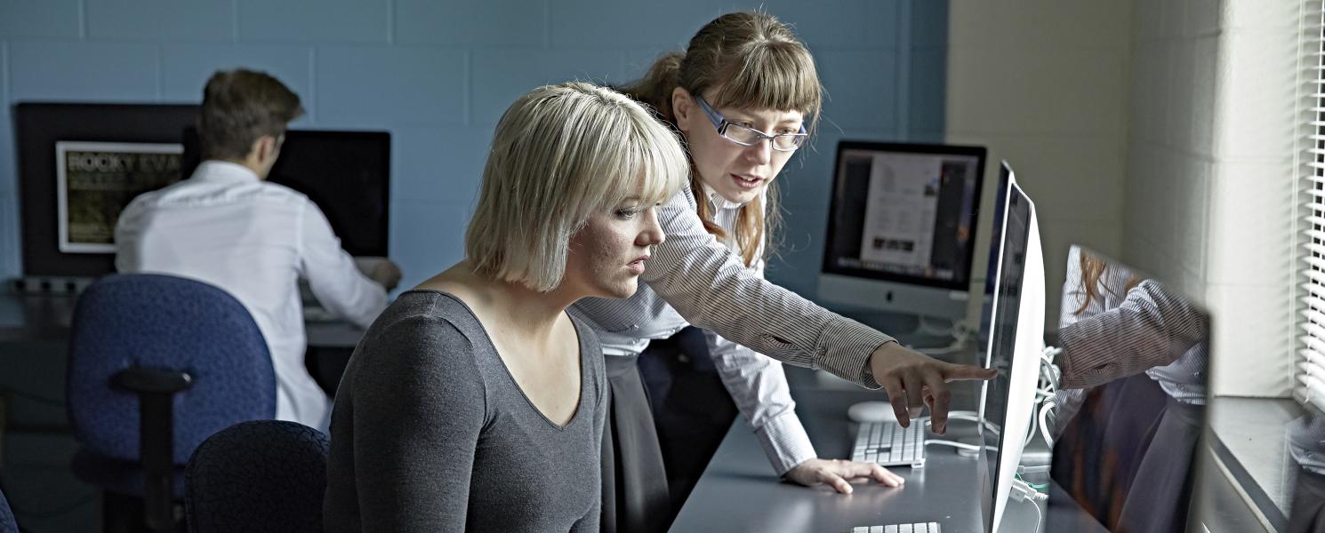A faculty member instructs in Photoshop