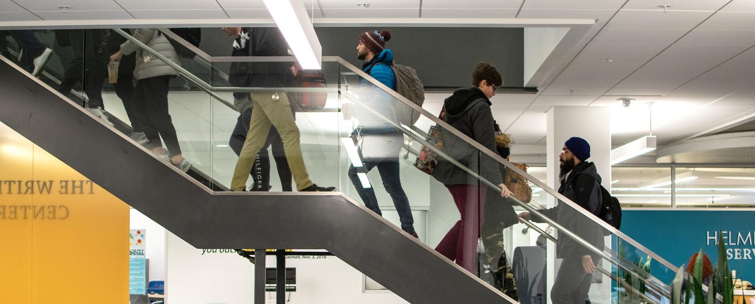 Students ascending and descending central library stairwell