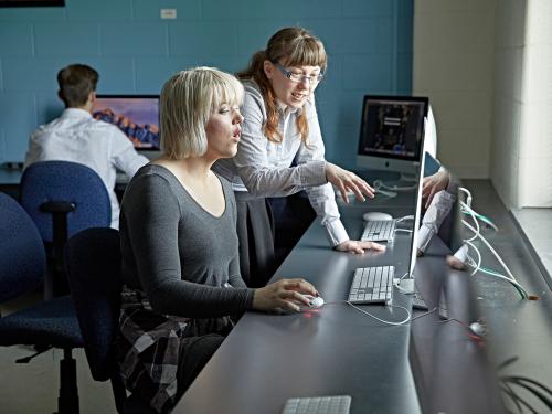 Student and professor at a computer