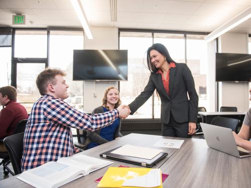 Handshake with business students.