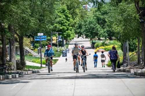 Cyclists ride through campus on the trails.