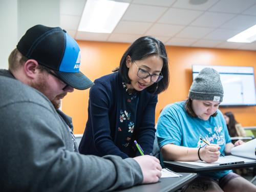 Professor Roberts assists students while they work on projects.