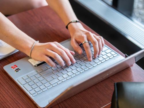 Someone is typing on a laptop computer.