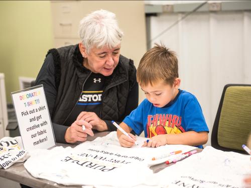 Child decorating shirt