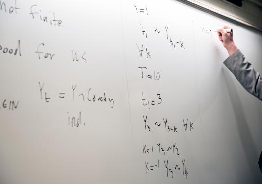 Whiteboard with math equations.
