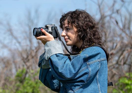 Portrait of Bella Ferrin taking pictures outside