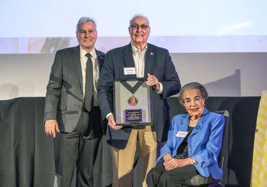 Former Indiana State senator Thomas J. Wyss stands with Chancellor Ron Elsenbaumer and Dorothy Shaffer, widow of Paul Shaffer
