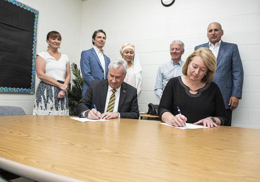 Chancellor Elsenbaumer and Superintendent Dawn Starks sign a memorandum of understanding.
