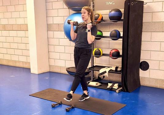 Health Coach Lindsay Bloom using hand-held weights for strength class