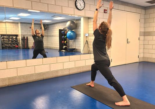 Health coach LIndsay Bloom demonstrating yoga pose