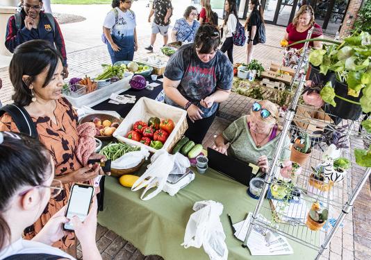 Vendors and wait on customers at the Plowshares Mobile Market