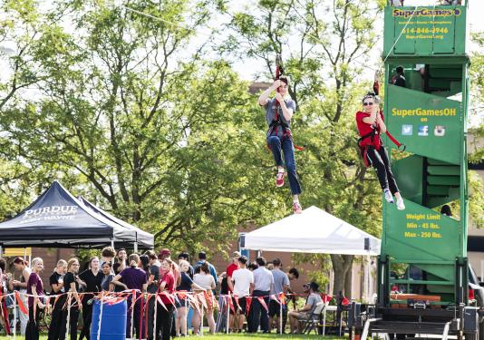 Two Dons race down the zipline at the annual Picnic on the Lawn on Sept. 7.