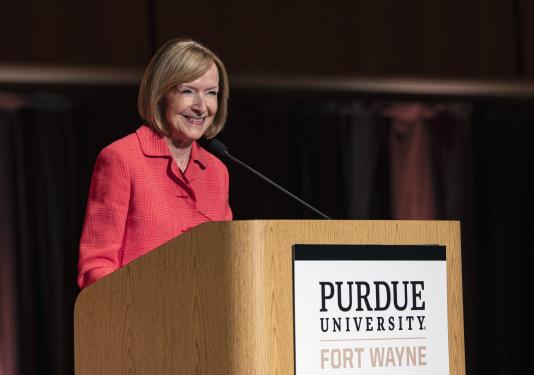 Judy Woodruff speaking from the lectern