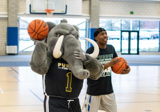 Student and don playing basketball