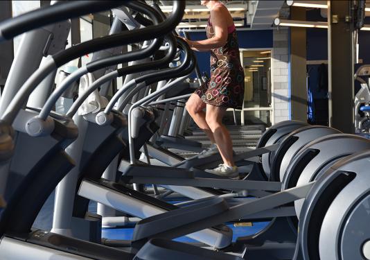 Person using the elliptical machine at the Fitness Center in Gates Center