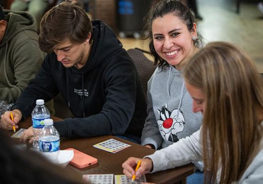 Smiling students at a bingo game