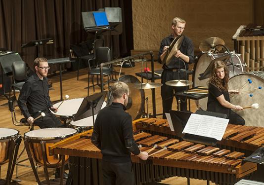 group of people on stage playing percussion instruments