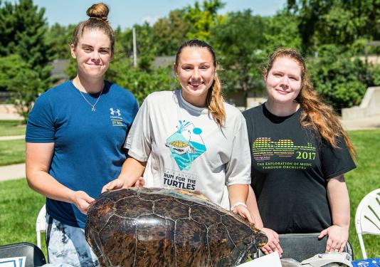 Members of the Biology Club display a large turtle shell
