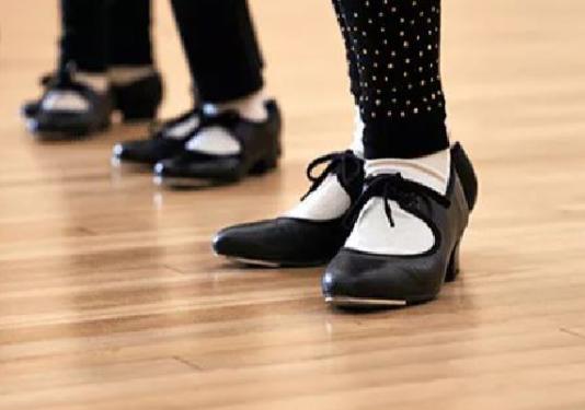 Tap dancers shoes on wood floor.