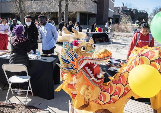 Students browse the tables at the Asian Heritage Festival on the Alumni Plaza