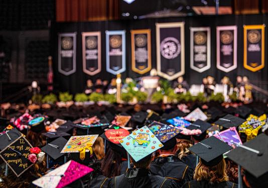 Students look toward the stage at commencement.