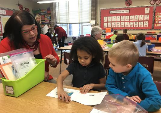 Maria Norman is working with elementary school students.