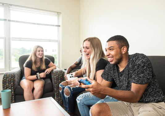 Students on a couch in housing.