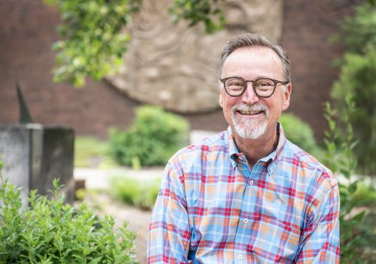 Portrait of Wylie Sirk in front of Neff Hall.
