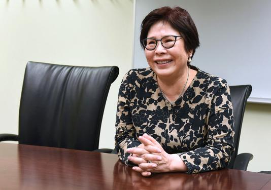 Portrait of Sheena Choi sitting at a desk