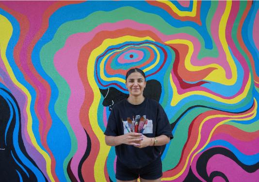 girl with colorful painted mural