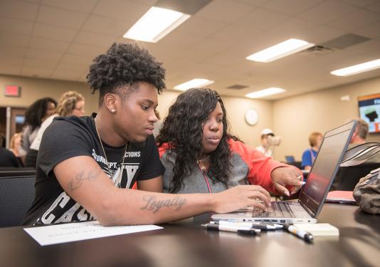 A student and parent fill out FAFSA forms at PFW.