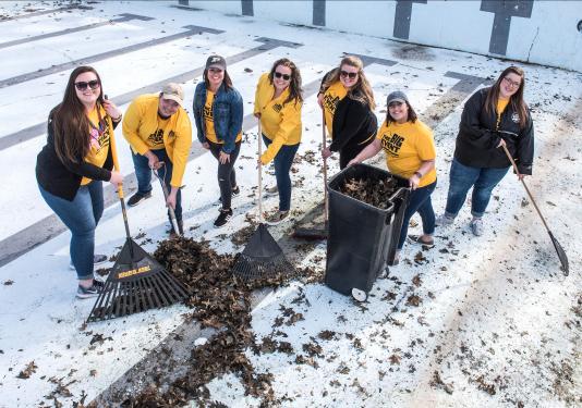 Students raking leaves