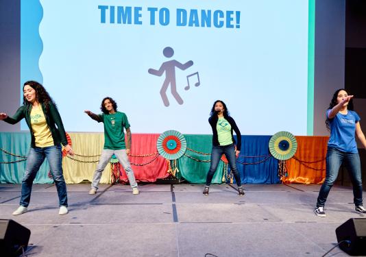 Four students are dancing at the 2022 Global Student Celebration