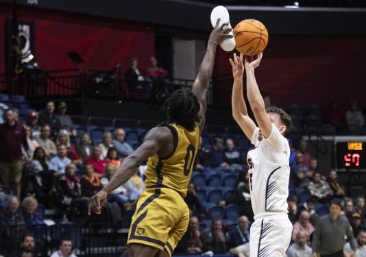 Rasheed Bello blocks a shot with his shoe (photo courtesy of MaCabe Brown of the Evansville Courier & Press)