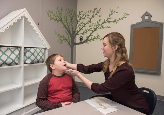 Speech language pathologist working with patient
