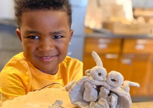 child making pottery