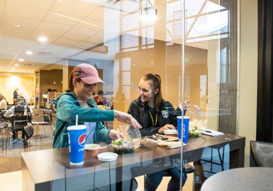 Two people are eating at a counter at Don's at Walb