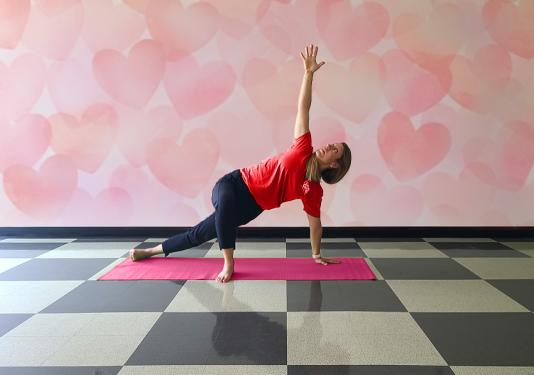 Yoga instructor showing how to do the maodified side plank for February's Employee Yoga class.