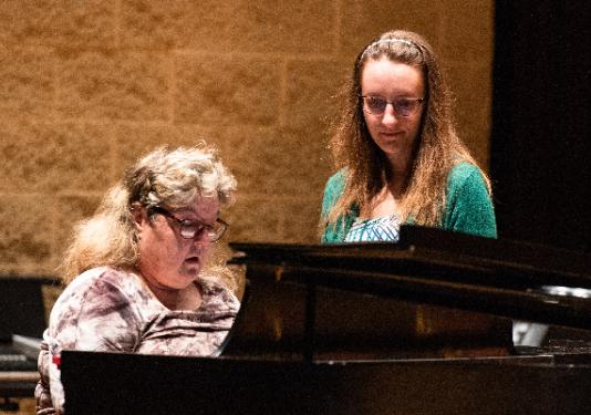 two women playing piano