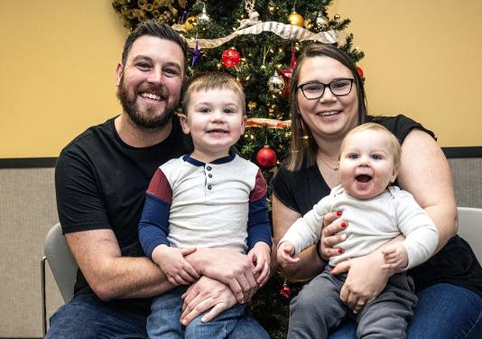 Portrait of Phill Tanner and his wife and two children