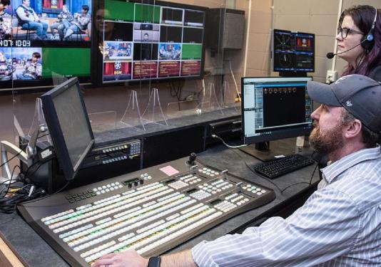 two adults editing camera footage
