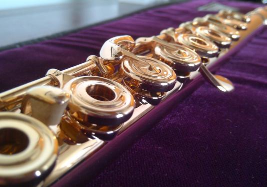 upclose picture of flute on purple cloth 