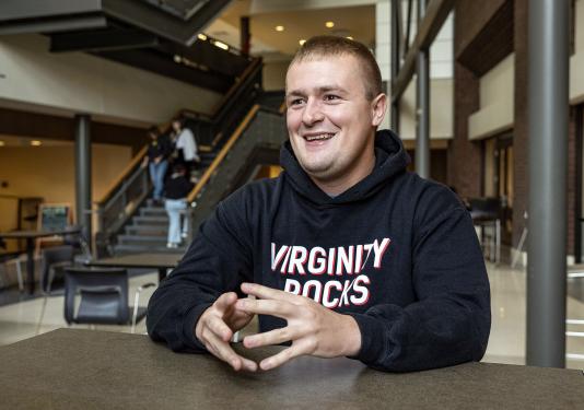 Evan Gregory is seated in the Walb Union Atrium